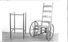 SA0650 - Photo of furniture for invalids, a wheelchair with rockers and wooden walker.